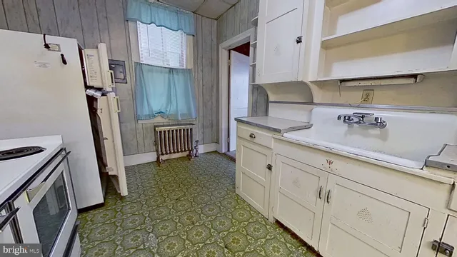 a kitchen with granite countertop a refrigerator and a stove