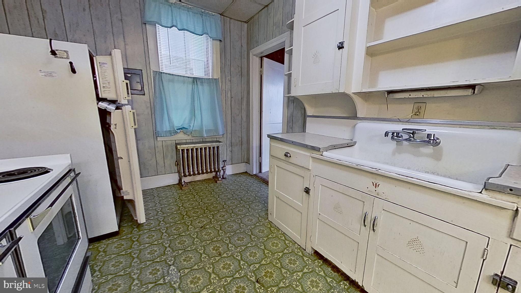 17 East Main Street, Unit 4 Dallastown, PA 17313 - Photo 3 of 8 a kitchen with granite countertop a refrigerator and a stove