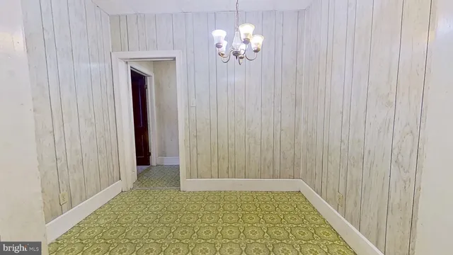 a view of entryway and hall with a wooden door