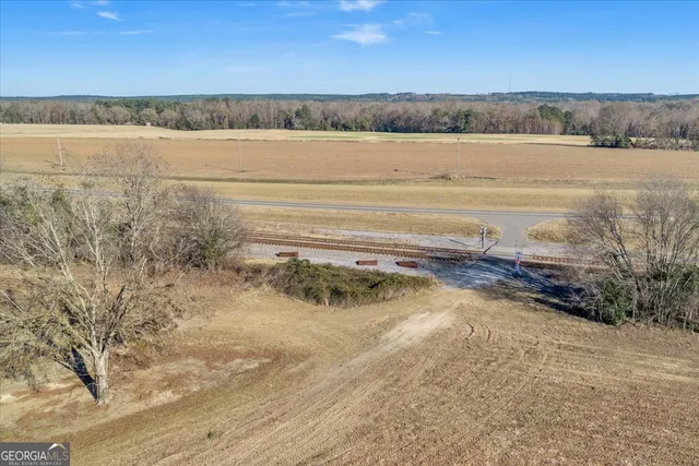 an aerial view of a house with a yard and lake view