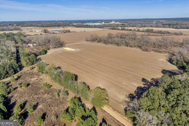 an aerial view of a house with a yard and mountain view