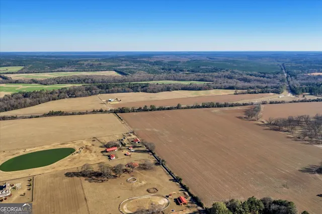 an aerial view of a house with a yard and lake view