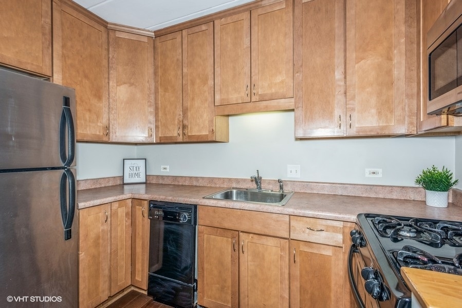 1000 South Lorraine Road, Unit 307 Wheaton, IL 60189 - Photo 3 of 10 a kitchen with stainless steel appliances granite countertop a sink stove and refrigerator