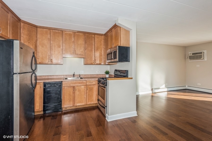 1000 South Lorraine Road, Unit 307 Wheaton, IL 60189 - Photo 4 of 10 a kitchen with a refrigerator stove and wooden cabinets