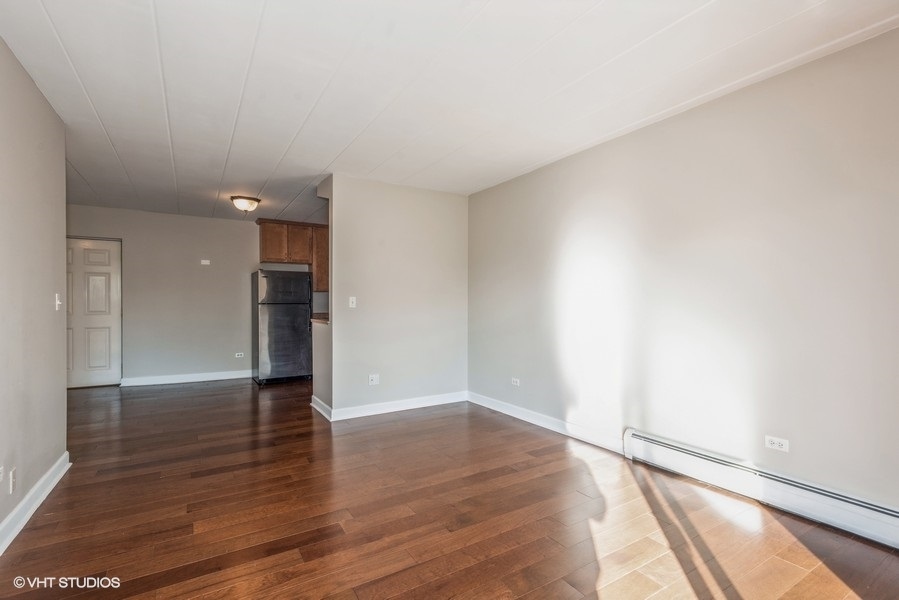 1000 South Lorraine Road, Unit 307 Wheaton, IL 60189 - Photo 6 of 10 a view of an empty room with wooden floor and a window