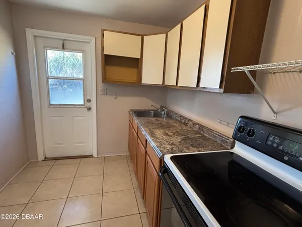 a kitchen with a refrigerator sink and cabinets