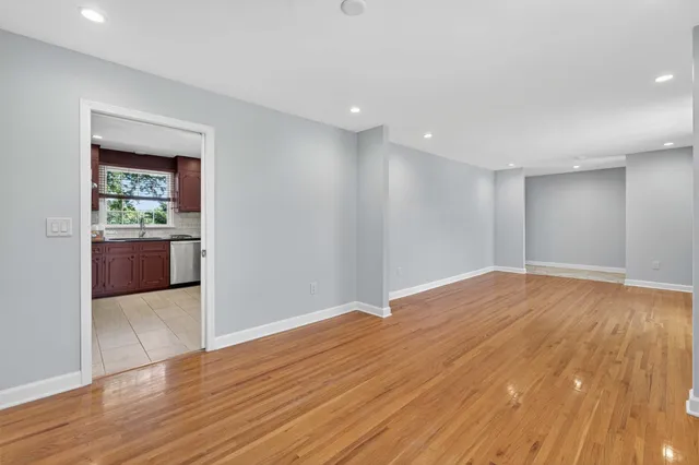 a large kitchen with stainless steel appliances granite countertop a stove a sink dishwasher and a refrigerator with cabinets