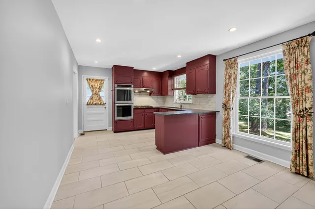 a view of a hallway with wooden floor and entryway