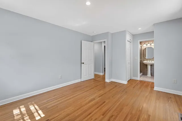 an empty room with wooden floor