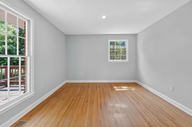 a view of a hallway with wooden floor and entryway