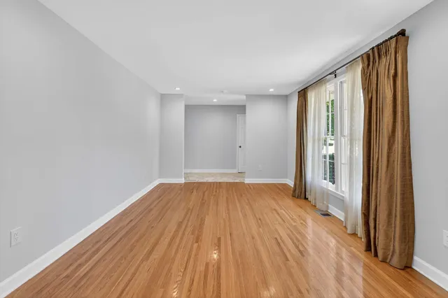 a view of hallway with wooden floor