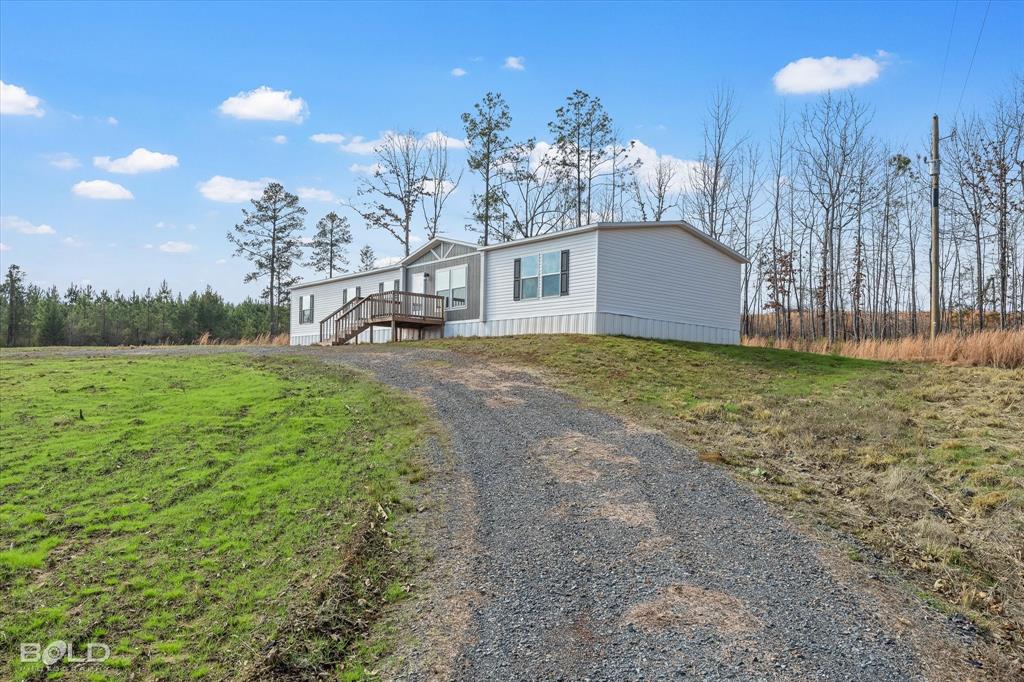 10565 Highway 3 Plain Dealing, LA 71064 - Photo 36 of 37 View of front facade featuring driveway and a front yard