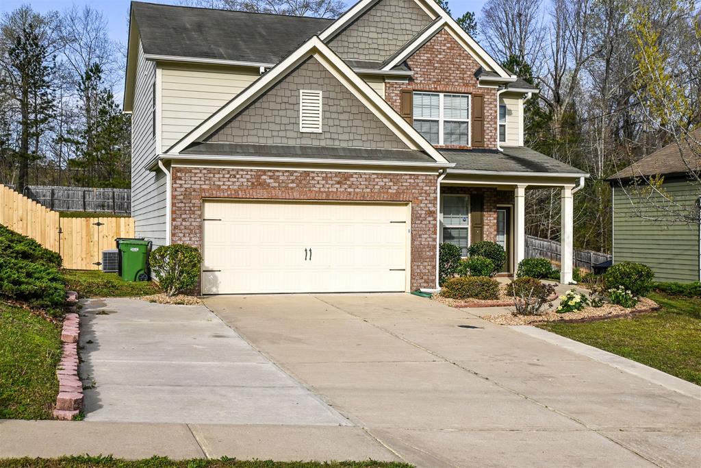 4447 Walking Stick Way Columbus, GA 31907 - Photo 1 of 26 a front view of a house with a yard and garage