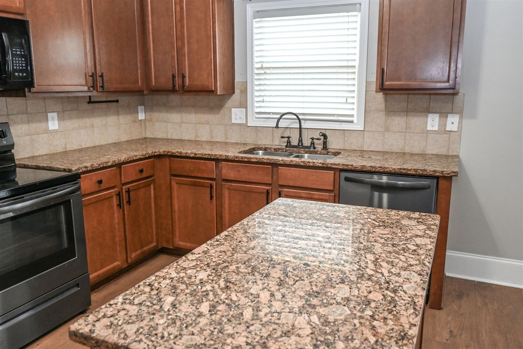 4447 Walking Stick Way Columbus, GA 31907 - Photo 11 of 26 a kitchen with stainless steel appliances granite countertop a sink stove and microwave