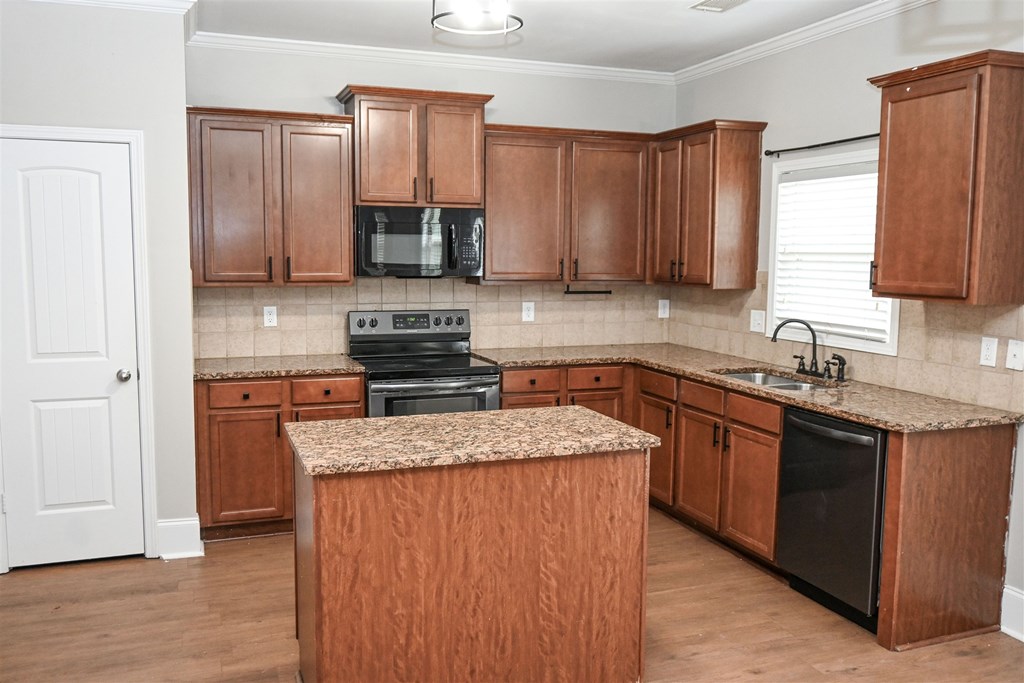 4447 Walking Stick Way Columbus, GA 31907 - Photo 9 of 26 a kitchen with stainless steel appliances granite countertop a sink stove refrigerator and cabinets