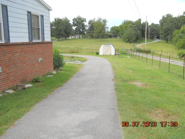 405 Thomas Road Lebanon, TN 37087 - Photo 5 of 12 a view of a garden with a lake