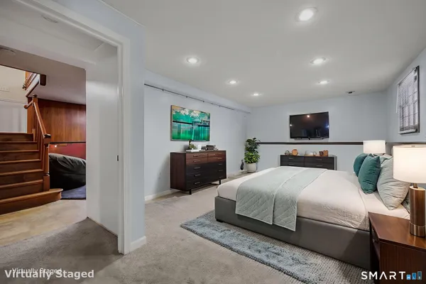 a bedroom with a bed and a view of en suite bathroom