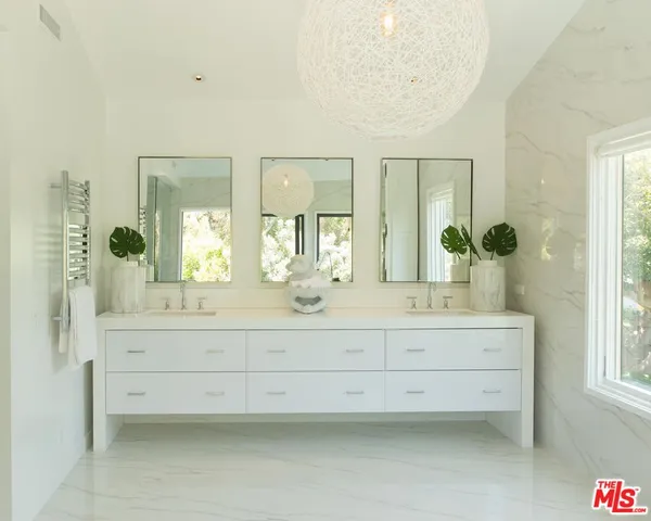 a bathroom with a sink mirror and a bathtub