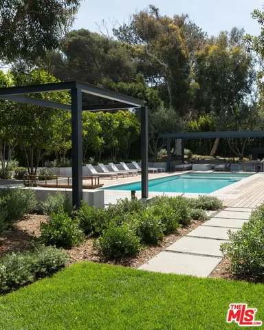 a view of backyard with green space and porch