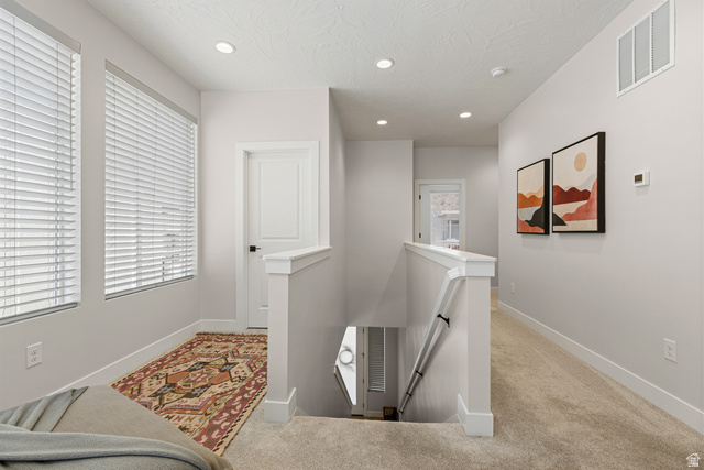 839 Walker Way St. George, UT 84770 - Photo 23 of 32 Upper-level hallway featuring a carpeted floor, recessed ceiling lighting, and white trim