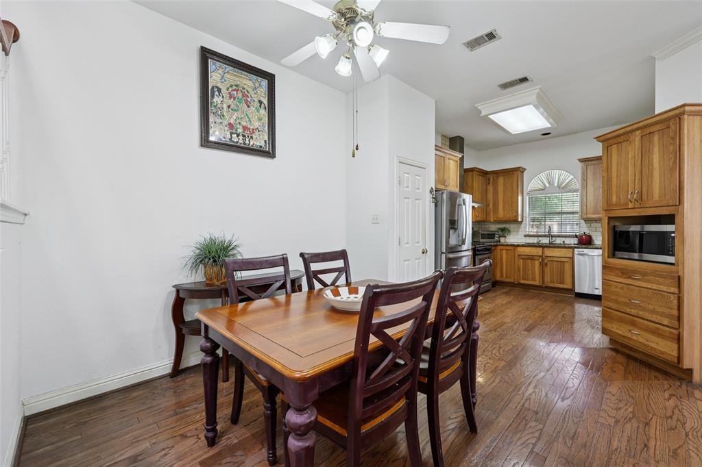 3004 Springfellow Drive Plano, TX 75025 - Photo 12 of 37 a view of a dining room with furniture and wooden floor