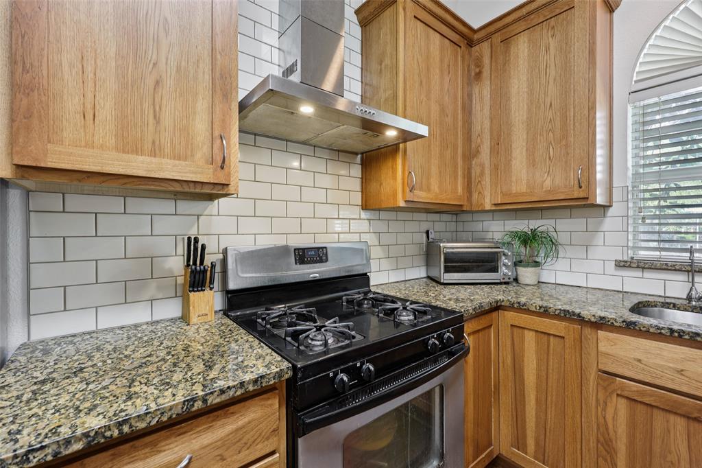3004 Springfellow Drive Plano, TX 75025 - Photo 14 of 37 a kitchen with a stove and a sink