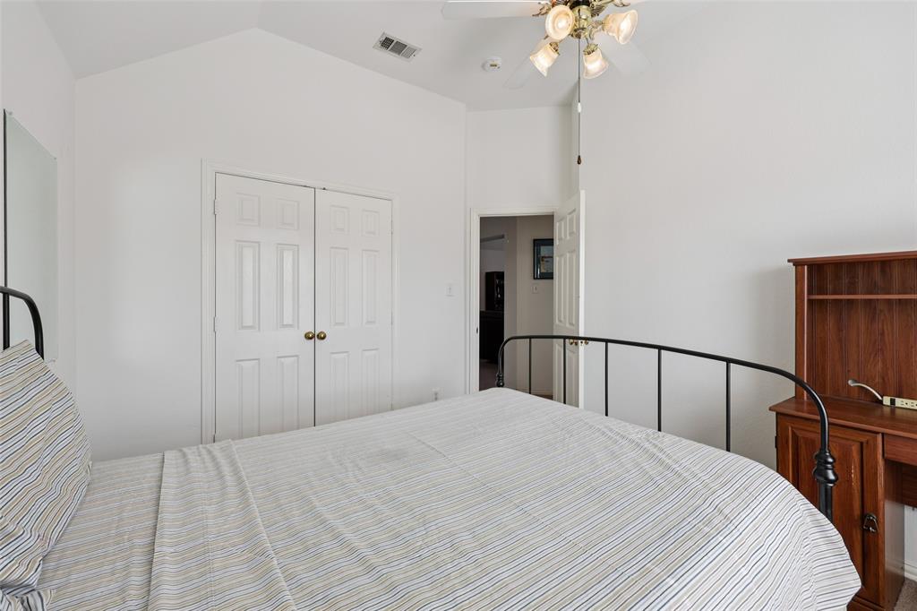 3004 Springfellow Drive Plano, TX 75025 - Photo 24 of 37 a bedroom with a bed and a chandelier