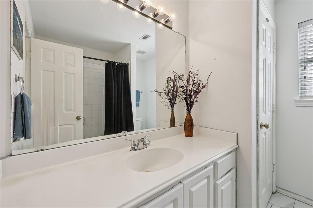 3004 Springfellow Drive Plano, TX 75025 - Photo 25 of 37 a bathroom with a granite countertop sink and a mirror