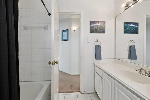 a bathroom with double vanity sink and a mirror
