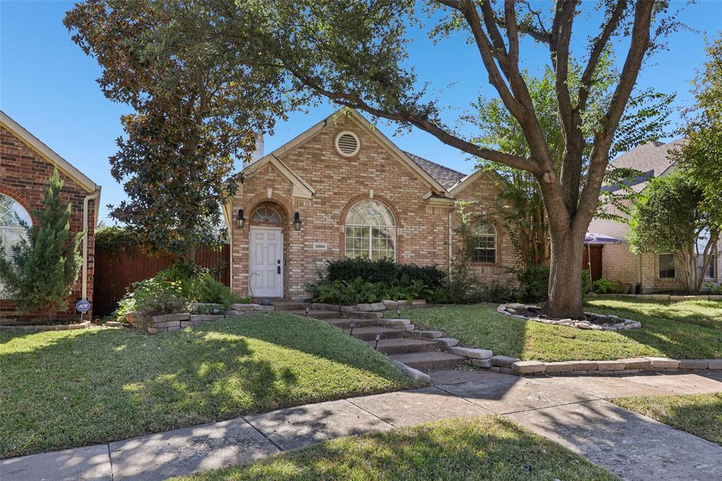 3004 Springfellow Drive Plano, TX 75025 - Photo 33 of 37 a front view of a house with a yard and garage