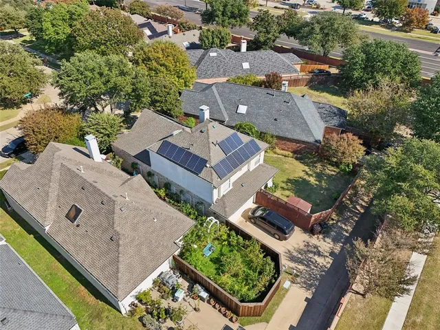 an aerial view of a house with a yard
