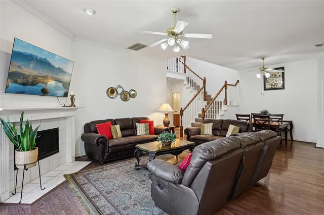 a living room with furniture a fireplace and a flat screen tv