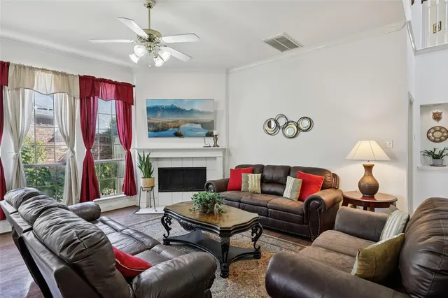 a living room with furniture flower pot and a fireplace