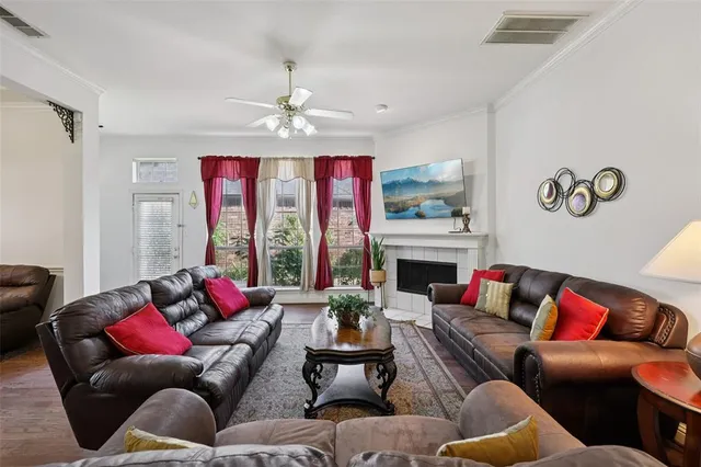 a living room with furniture fireplace and window