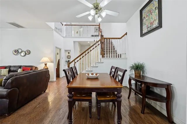 a dining room with furniture and wooden floor