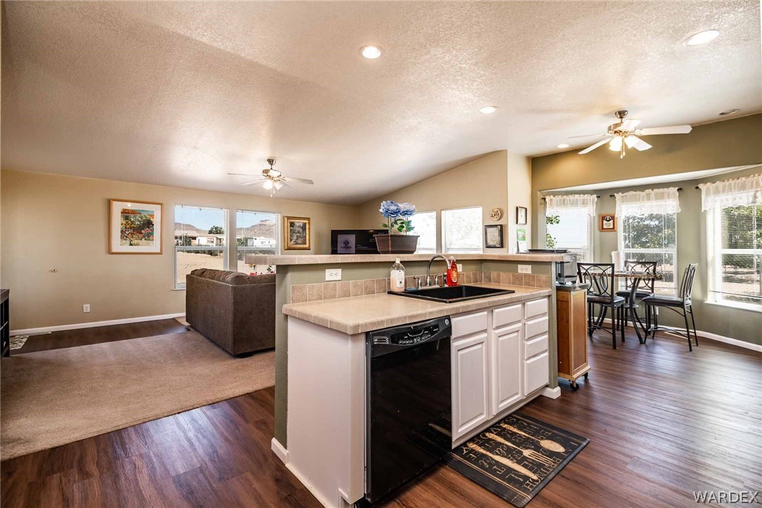 3398 Houck Road Golden Valley, AZ 86413 - Photo 4 of 50 a kitchen with stainless steel appliances granite countertop a stove top oven a sink dishwasher and a dining table with wooden floor