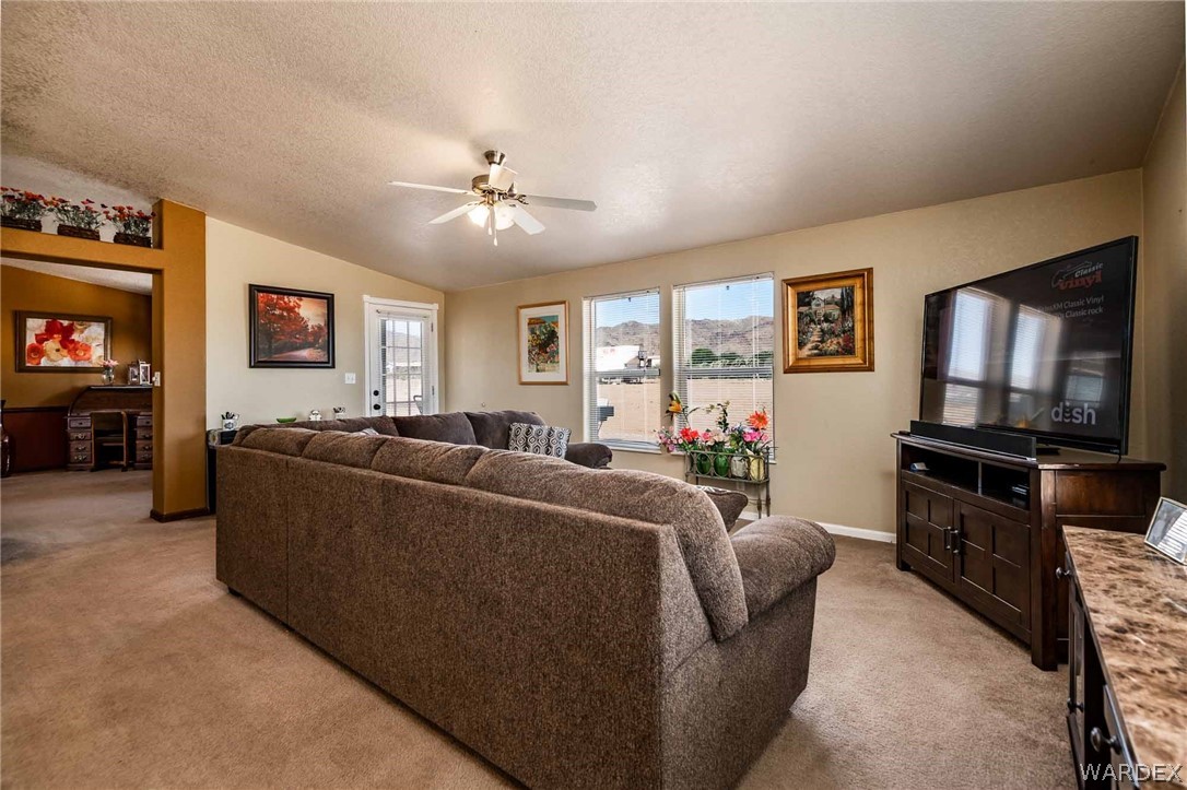 3398 Houck Road Golden Valley, AZ 86413 - Photo 8 of 50 a living room with furniture and a flat screen tv