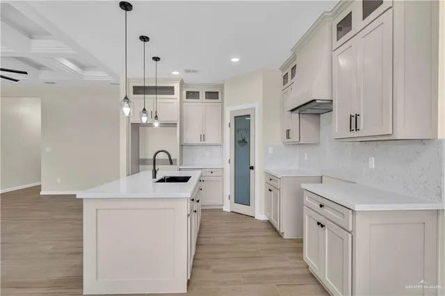 a kitchen with white cabinets stainless steel appliances and sink