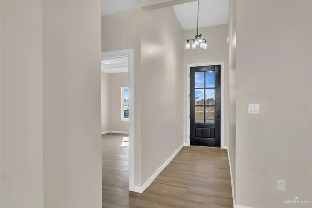 a view of a hallway with wooden floor