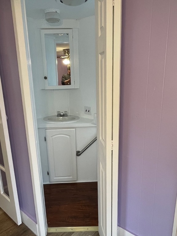 252 Newbury Street, Unit 71 Peabody, MA 01960 - Photo 3 of 22 a bathroom with a sink a toilet a mirror and vanity