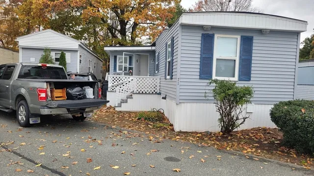 a car parked in front of a white house