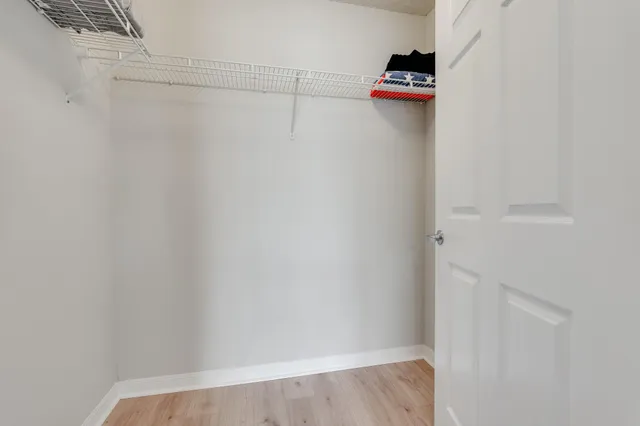 a bathroom with a granite countertop sink toilet mirror and shower