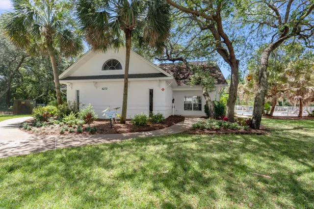 a view of a house with backyard sitting area and garden