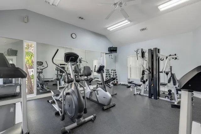 a view of swimming pool that has lawn chairs with plants