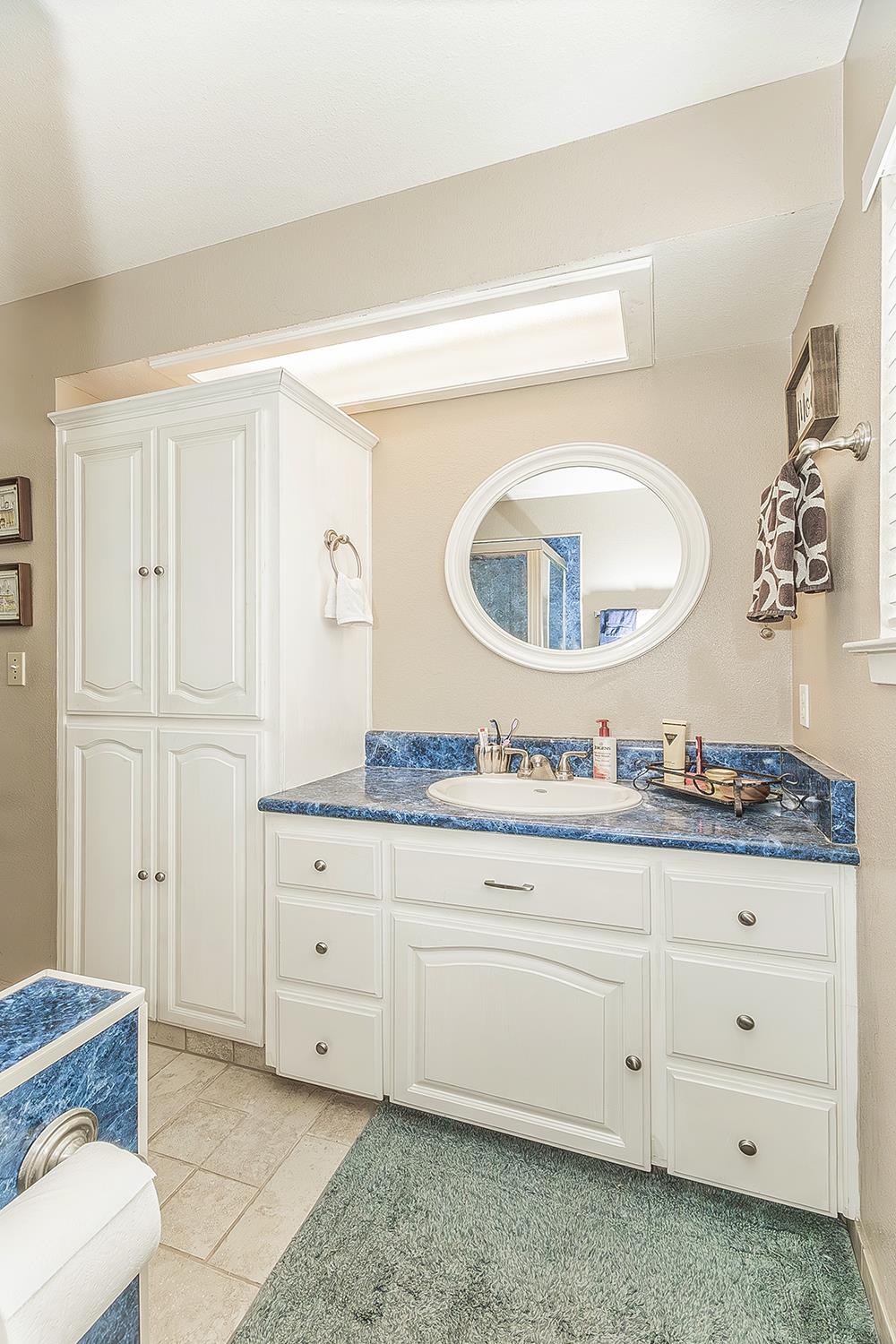1908 East Niles Avenue Fresno, CA 93720 - Photo 23 of 30 a bathroom with a granite countertop toilet sink and mirror
