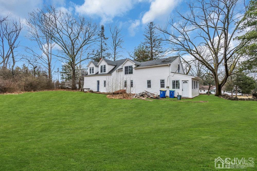 700 Foothill Road Bridgewater, NJ 08807 - Photo 22 of 30 a view of a white house in front of a big yard with large trees