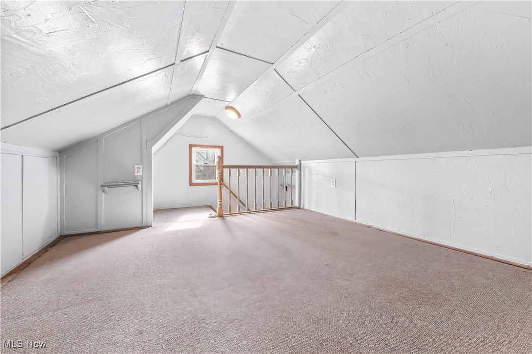 349 Gibbs Road Akron, OH 44312 - Photo 23 of 31 Bonus room featuring carpet flooring and vaulted ceiling