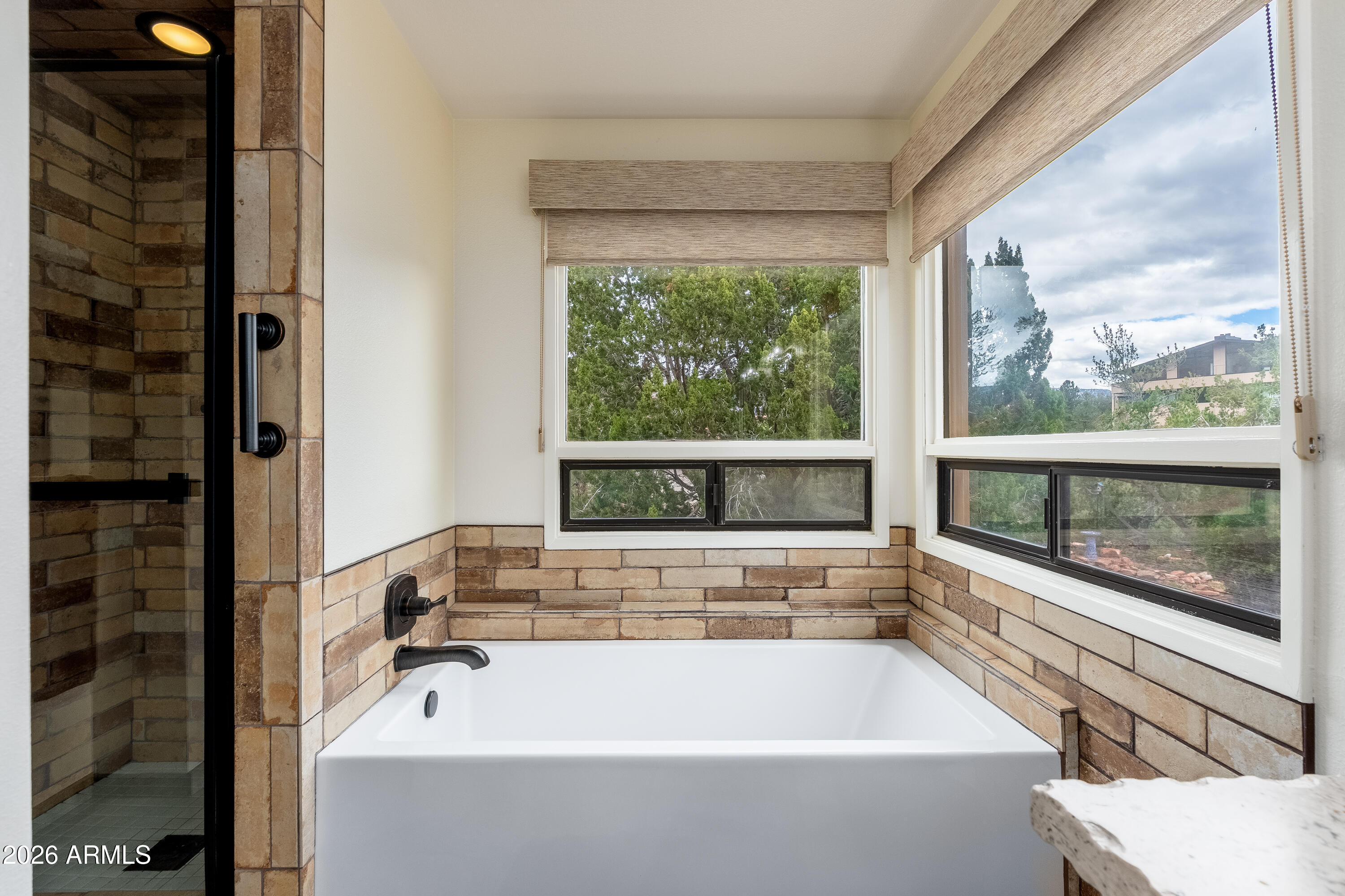 30 Kashmir Road Sedona, AZ 86336 - Photo 20 of 57 a bathroom with a bathtub and window