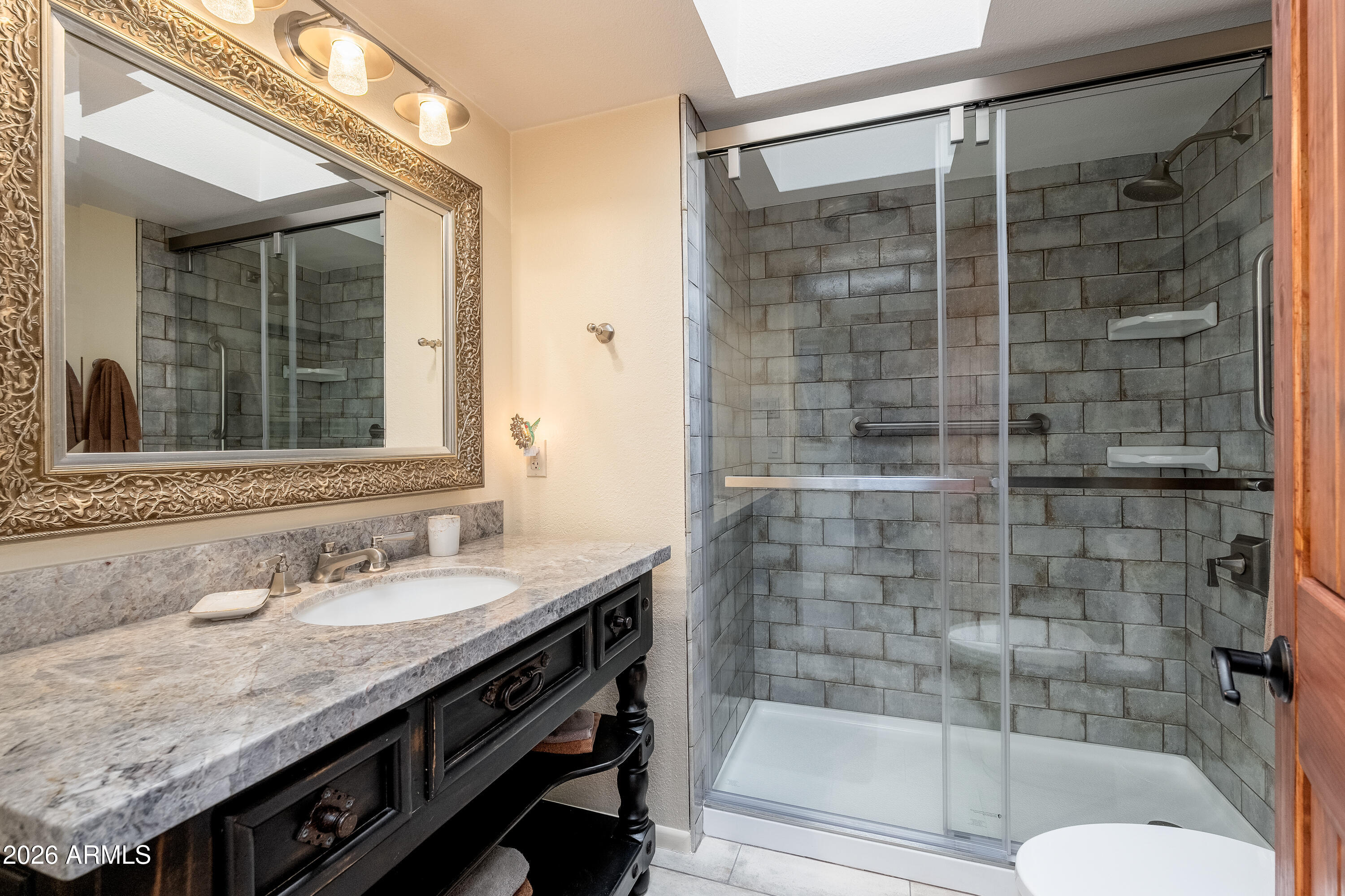 30 Kashmir Road Sedona, AZ 86336 - Photo 25 of 57 a bathroom with a granite countertop sink a mirror and shower