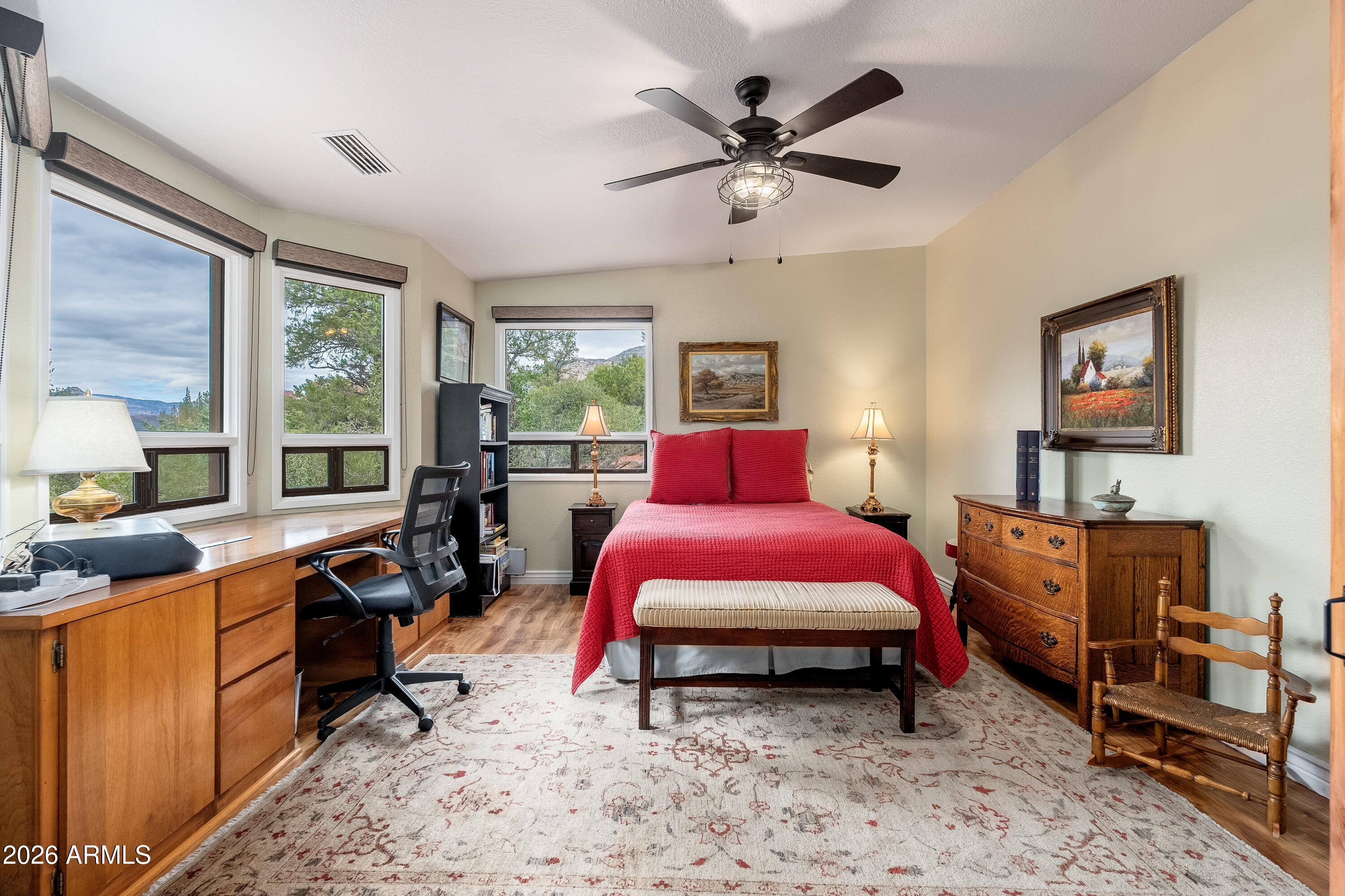 30 Kashmir Road Sedona, AZ 86336 - Photo 26 of 57 a bedroom with a bed a desk and chair with the walls